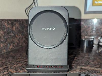 Phone stand for wireless puck charger