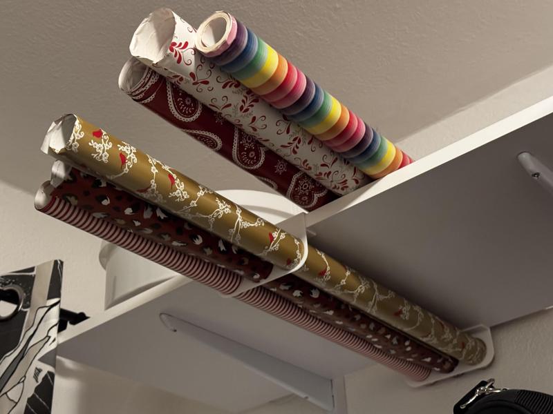 Gift wrap roll holder for shelf