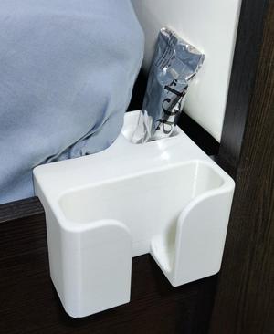 Phone shelf on the edge of the bed