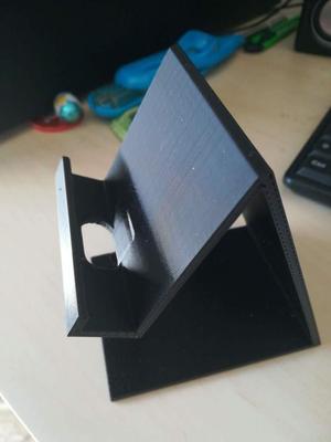 Mobile phone stand with hole for charger