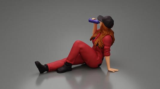 Tired woman mechanic in suit and cap sitting and drinking water during from bottle
