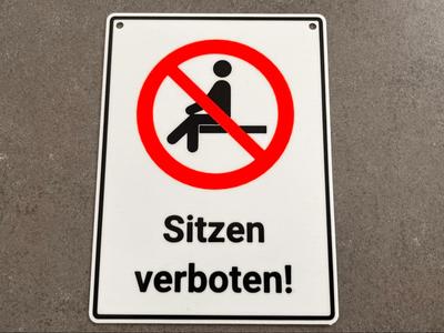 Prohibition sign "No sitting!" in German AMS