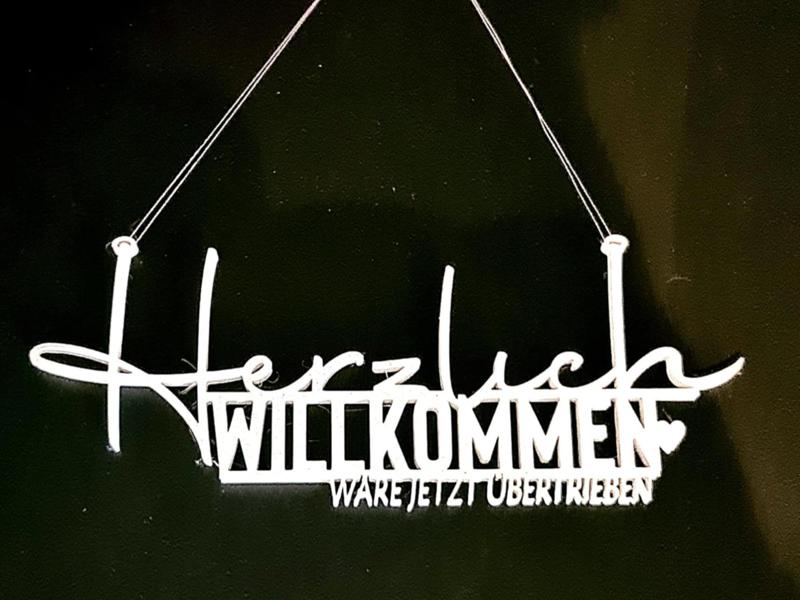 A hearty welcome would be an exaggeration Door sign