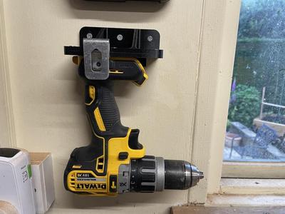 Dewalt DCD796 cordless drill holder and bracket, fitted flush to a wall.