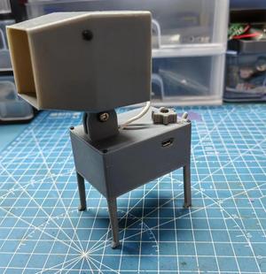 A slender dog using a fan