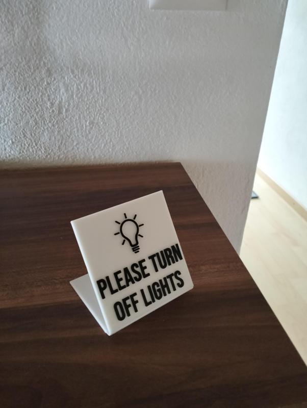 "please turn off lights" sign
