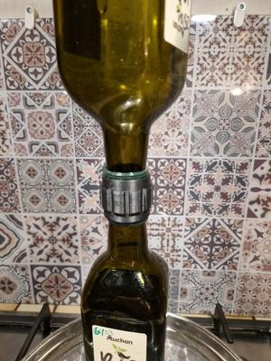 Bottle connector/holder for draining oil