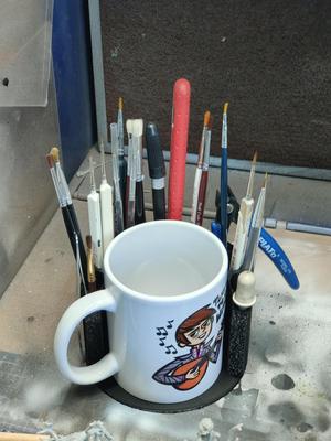 A simple brush holder with a space for a cup