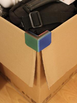 Cardboard box flap holder corner