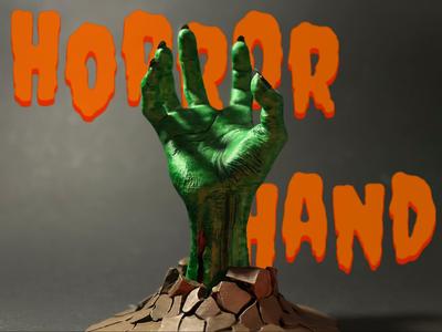 Terrifying horror hand breaking through the ground
