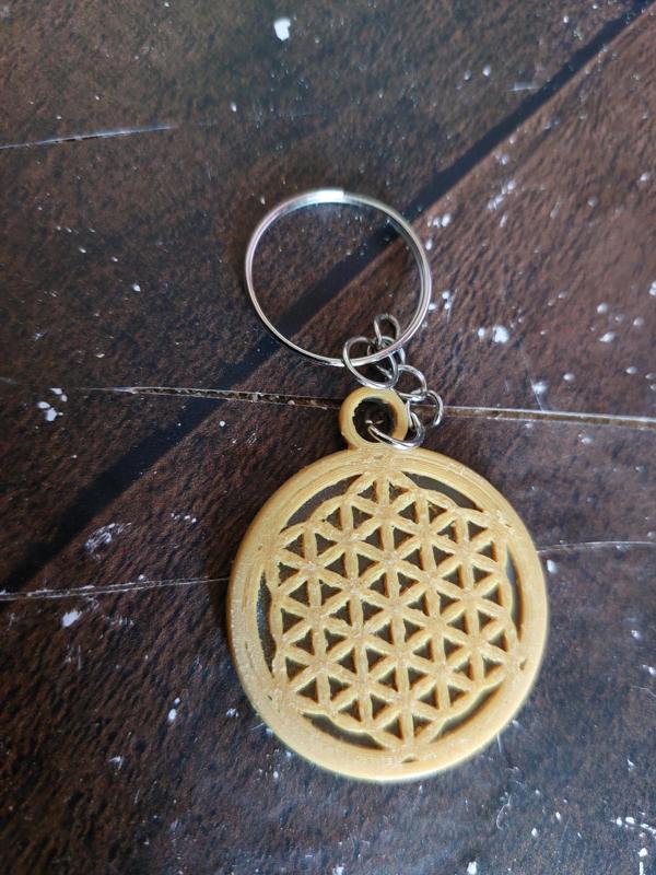 a small flower of life key ring