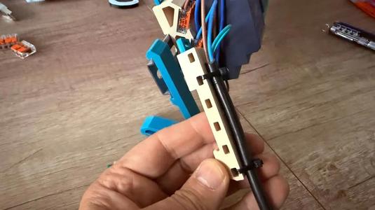 Universal DIN rail mount with screw holes and zip tie slots   