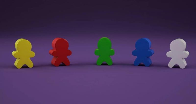 Low-poly meeple group of different colored wooden figures