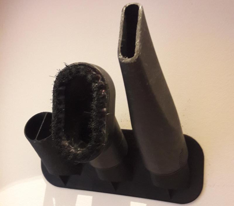 Holder for vacuum cleaner nozzles