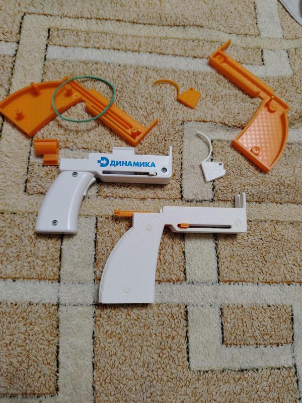 Injection gun with a syringe. Gun for injections at home. Makes an automatic sharp injection.