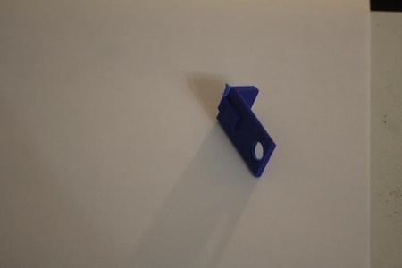 Sliding bracket to hold object in place