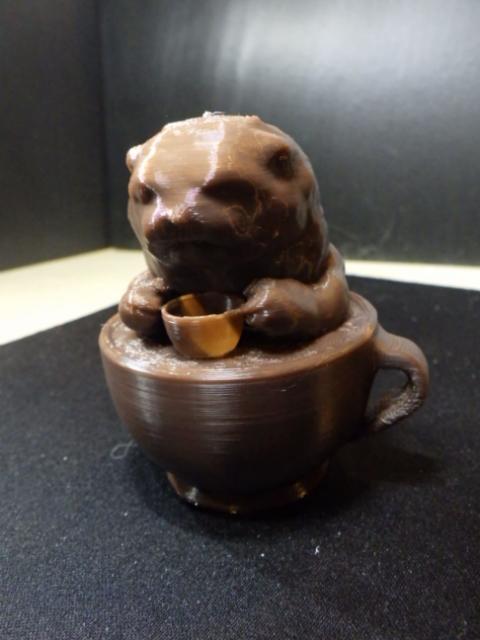 Cute Otter drinking coffee