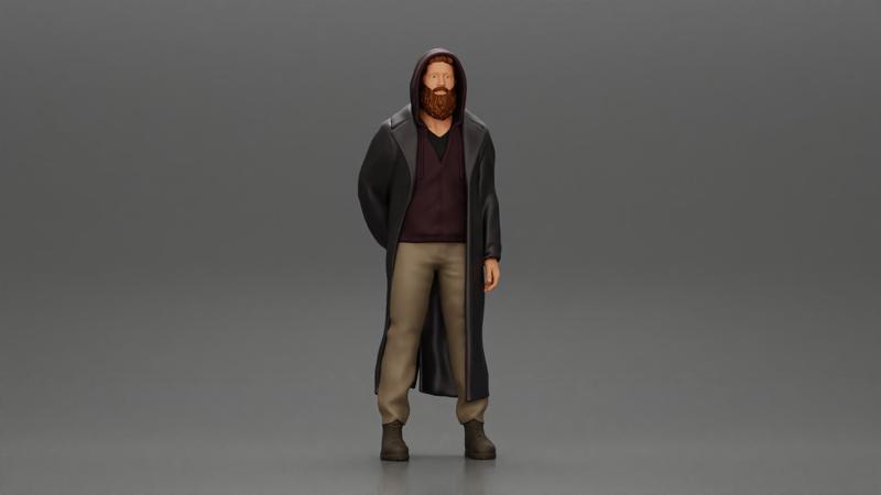 bearded man stands confidently adorned in a stylish hoodie and a flowing long coat