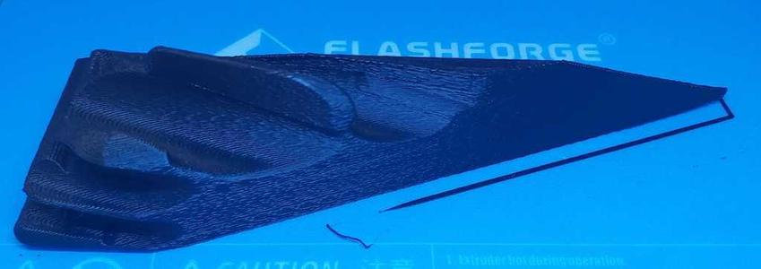 Aerodynamic mudguard for an automotive vehicle