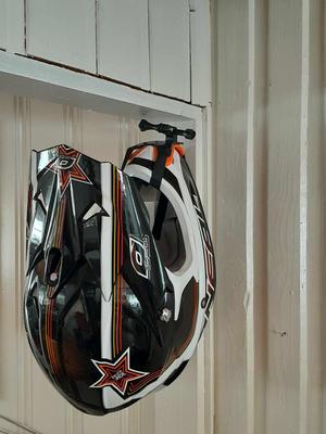 Wall mounted helmet holder