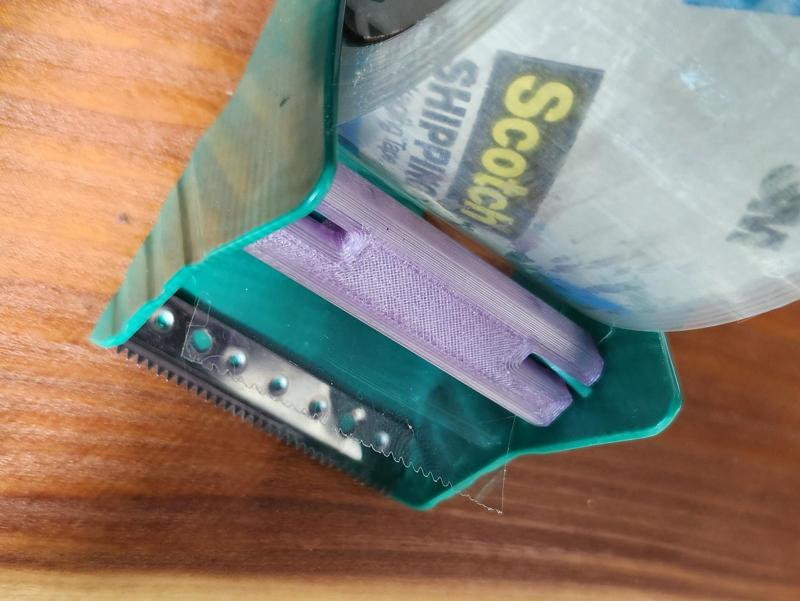 "Duck" brand clear packing tape dispenser retaining bar