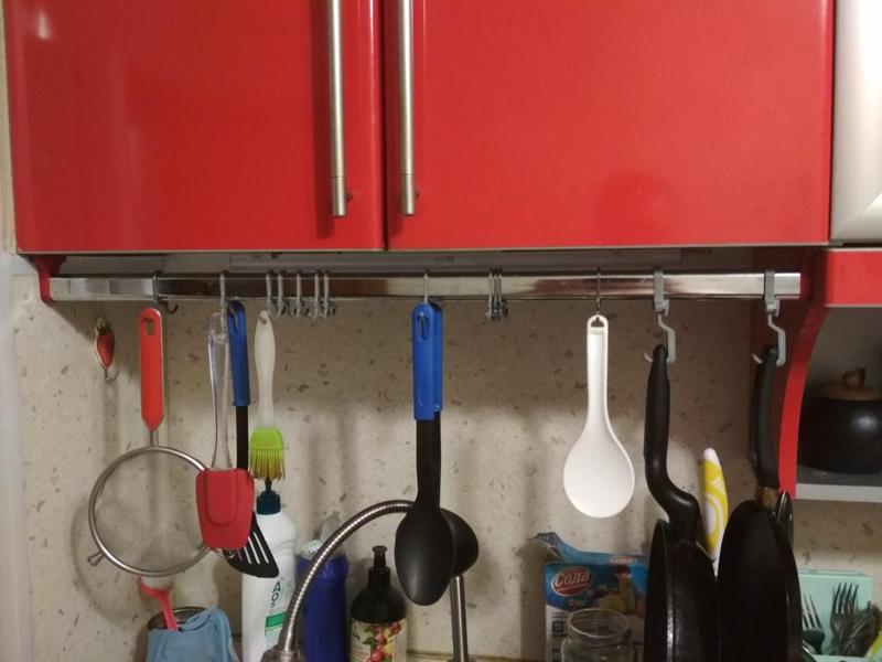 Kitchen hooks on oval clothes rail