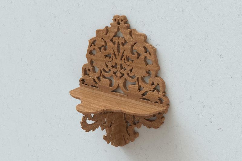 Carved wall shelf