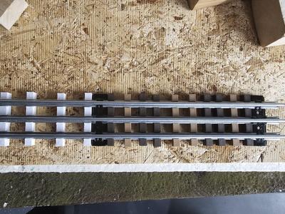 O gauge rail tie for tubular track