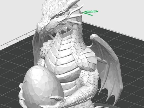 dragon figure holding an egg