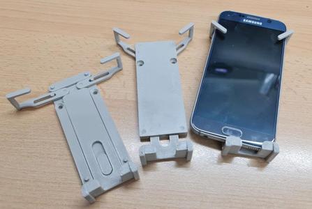 Universal wall mounted cellphone holder