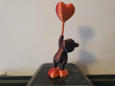 Teddy bear with heart balloon