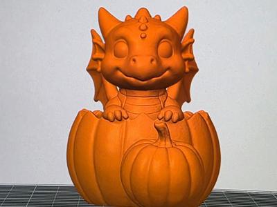 Baby Dragon sitting in a Pumpkin