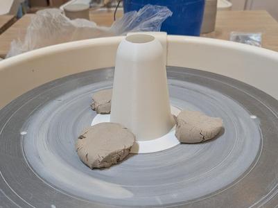 Pottery trimming chuck and rim rounding cone