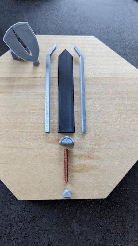 Figure of Guts' sword stuck in a shield, Manga Berserk