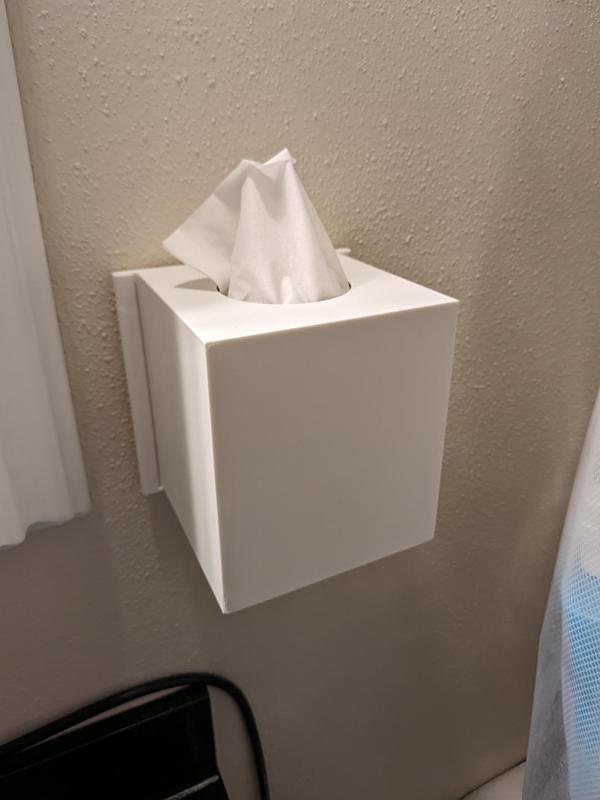 Tissue box with adhesive strip mount