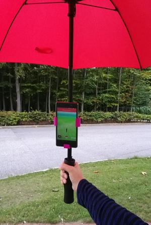 Universal phone holder for an umbrella