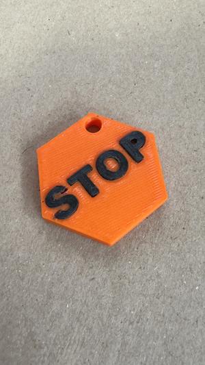 Keychain with word "STOP" like a STOP sign