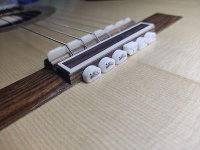 String attachment system for classical guitar