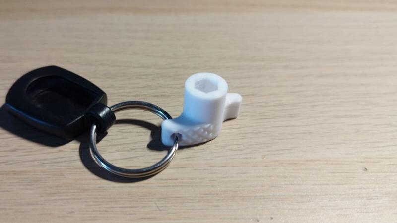 Bit driver with relief cutouts and keyring hole