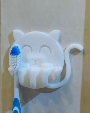 Catty toothbrush hanger