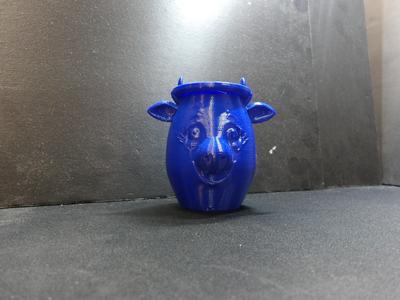 A cow face flower pot for plants.