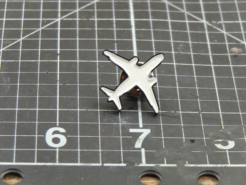 Plane enamel pin