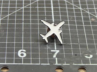 Plane enamel pin