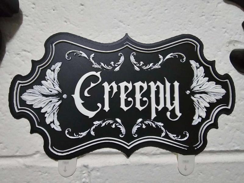 Creepy wall decor sign