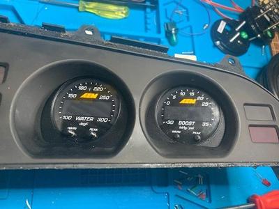 Supra Mk3 cluster's oil gauge adapter for AEM x-series gauge