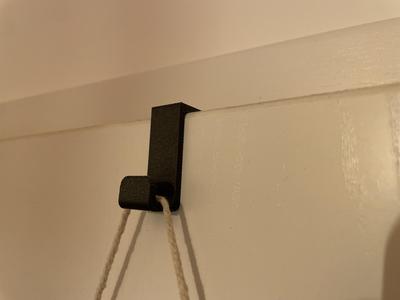 Coat hook for the door of the room