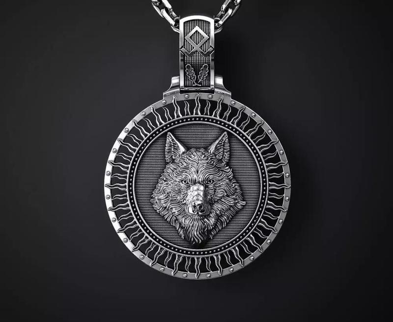 A PENDANT WITH A WOLF S HEAD AND A TREE OF LIFE