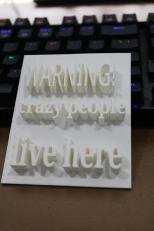 Warning crazy people live here sign   