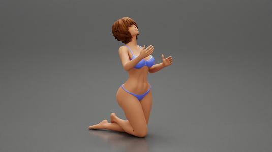 Sexy girl in bikini with short hair sitting on her knees