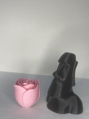 moai stone statue and a rose